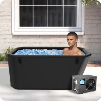 A man relaxing in a black outdoor ice bath filled with ice cubes, situated near a brick wall under a window.