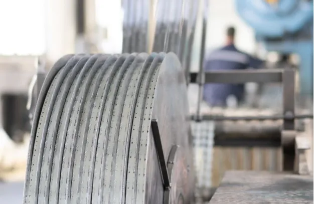 The work operates the machine for razor wire production.